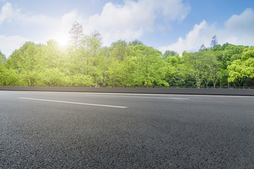 Asphalt road square and river hill under the blue sky