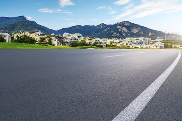 Asphalt road square and river hill under the blue sky