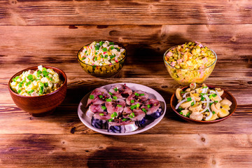 Different festive dishes on a wooden table