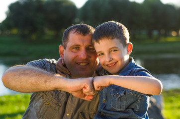 happy father and son playing together near the seaside
