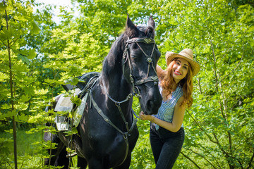 Obraz premium Nice american young girl at her horse dressing american style competition: outdoors portrait on sunny day, in hat. Rider elegant woman talking to her horse 