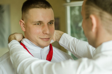 
witness at the wedding tie a groom
