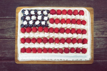 Patriotic, red white and blue, American flag cake, decorated with fresh blueberries and...