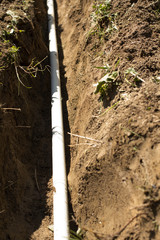 trench excavation on the building site for the water system/sewer system, ditch excavation
