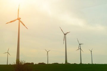 Windmills in the field. Concept of renewable energy, energy subs