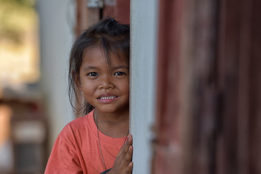 Smiling faces of young children or young people from rural Asia.