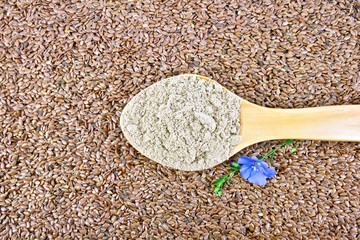 Flour linen in wooden spoon with flower on seeds