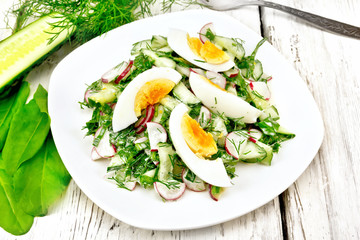 Salad with radish and egg in plate on table