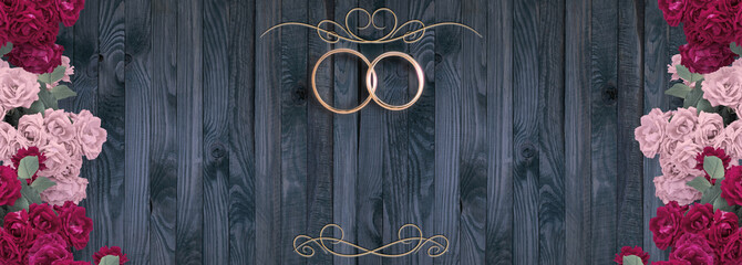 Top view of pink roses and bridal rings for wedding on background of shabby wooden planks