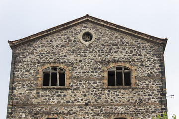 Fototapeta na wymiar Front close-up shot of abandoned masonry stone constructed old tobacco storage building in Izmir at Turkey