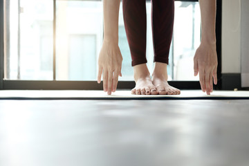 Young woman practicing yoga at home.