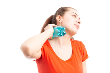 Sweating attractive young woman cooling with bottle of water.