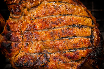 Obraz na płótnie Canvas A close-up of the pies of entrecote pork in teriyaki sauce is fried in a grill. Preparation of a shish kebab on a summer day at the cottage