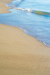 Beautiful waves on the beach from the ocean or the sea