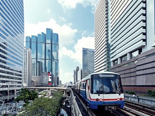 Buildings with Sky train in the city of Bangkok.
City transportation concept.