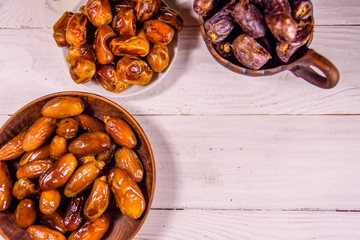 Date fruits on the white wooden table. Top view