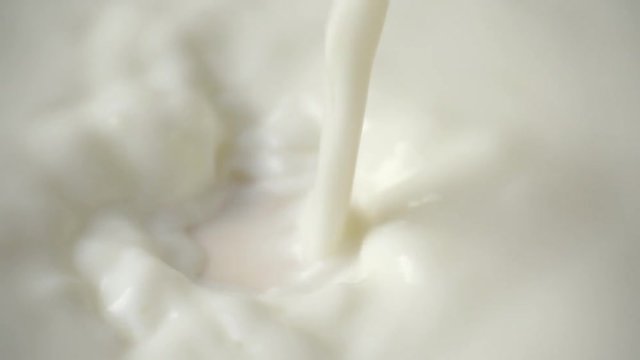 pouring milk and splashing in slow motion