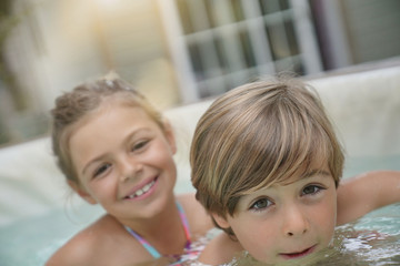 Portrait of kids enjoying hot jacuzzi water © goodluz