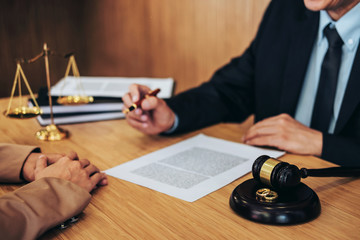 Marriage divorce on Judge gavel deciding, Consultation between a Businesswoman and Male lawyer or judge consult having yes or no to signing divorce documents, Law and Legal services concept
