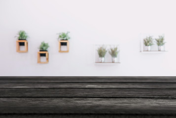 Empty wooden table and blurred background of abstract in front of coffee shop or restaurant for display of product or for montage