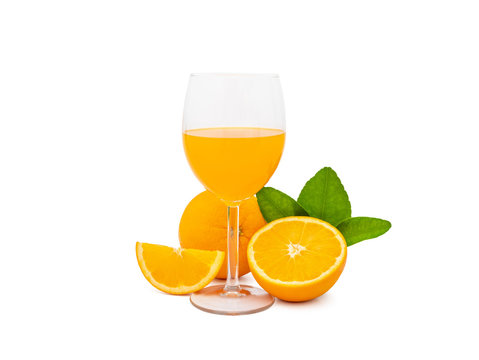 a glass of fresh orange juice and group of fresh orange fruits with green leaves, isolated on white background, clipping path include. fruit product display or montage, studio shot