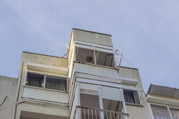 Bottom shot of reinforced concrete constructed old residential building of narrow street in Izmir at Turkey