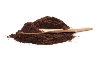 Pile of powdered, instant coffee with wooden spoon isolated on white background