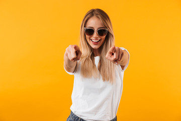 Portrait of a cheerful young blonde girl in sunglasses