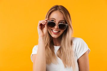 Portrait of a joyful young blonde girl in sunglasses