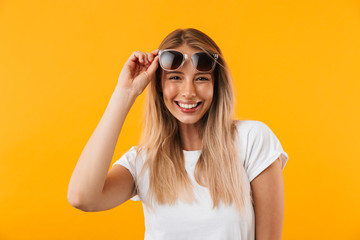 Portrait of a cheerful young blonde girl in sunglasses
