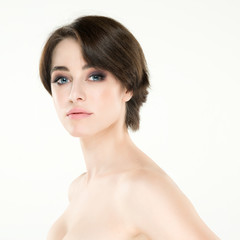 Fototapeta premium Beauty female portrait. Young attractive woman posing at studio over white background. Beautiful girl. Model with perfect make-up