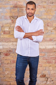 Portrait of a serious handsome young man in a white shirt.