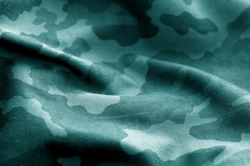 Military uniform pattern with blur effect in cyan tone.