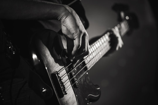 Electric bass guitar player hands, live music