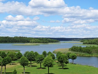 View at Panorama of Tranquil Lake with Trees and Clouds