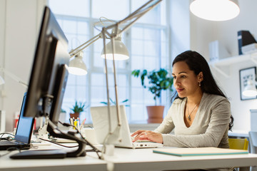 Woman using laptop in office