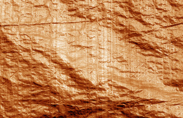 Plastic material uneven surface in orange color.