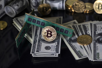 Bitcoins btc bit-coin stand on a black reflective background. RAM. Random access memory. One hundred dollar American bills. Crypto currency in cyberspace as a system of payment.