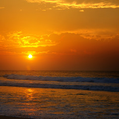 Beach of the ocean and golden sun rise.