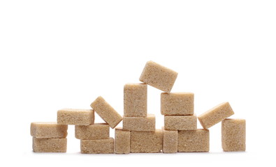 Brown cane sugar cubes isolated on white background