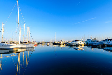 Modern sailboats and luxury yachts parked in the seaport on summ