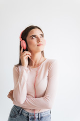 Portrait of a pretty young brunette girl listening to music