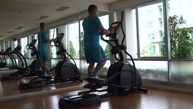 Man has an elliptical exerciser