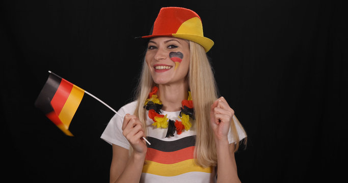 Young Enthusiast German Supporter Woman Smiling for Victory of his Preferred Football Germany Team Win in a Game in International Sport Event, Female Enjoy Waving Flag