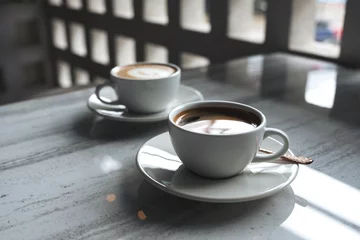 Fotobehang Closeup image of two white cups of hot coffee on table in cafe © Farknot Architect
