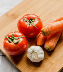 Raw vegetables on wooden board