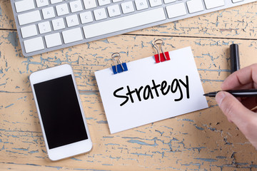 Paper note with text Strategy