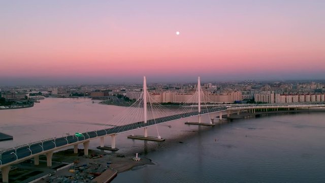 Boat Sailing under Western Rapid Diameter Highway during White Nights at Novokrestovskaya Metro Station and Saint-Petersburg Stadium from Aerial Drone Flight