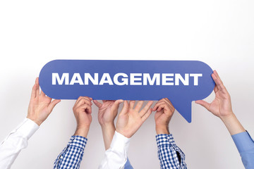 Group of people holding the MANAGEMENT written speech bubble