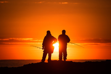 Two Men Fishing at Sunrise